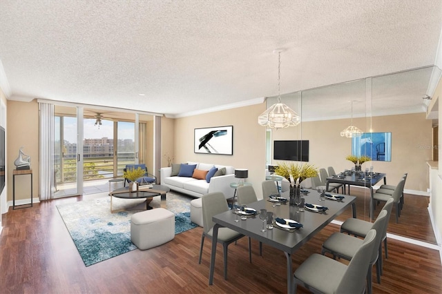 living area featuring a textured ceiling, ornamental molding, wood finished floors, and baseboards