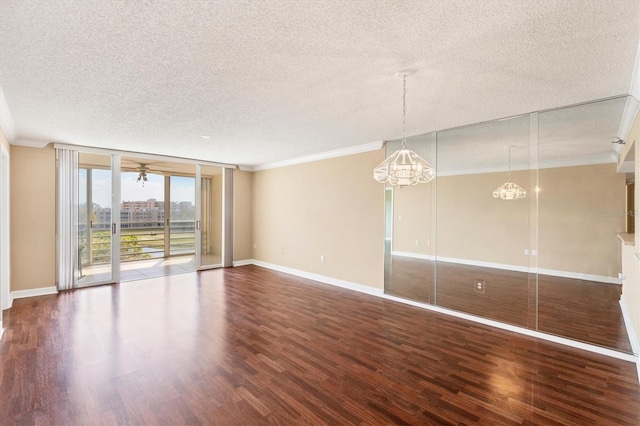 unfurnished room with baseboards, a textured ceiling, wood finished floors, and crown molding