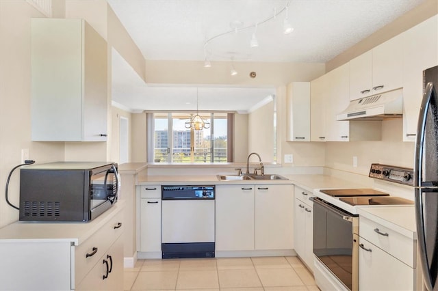 kitchen with white appliances, light countertops, under cabinet range hood, a sink, and light tile patterned flooring