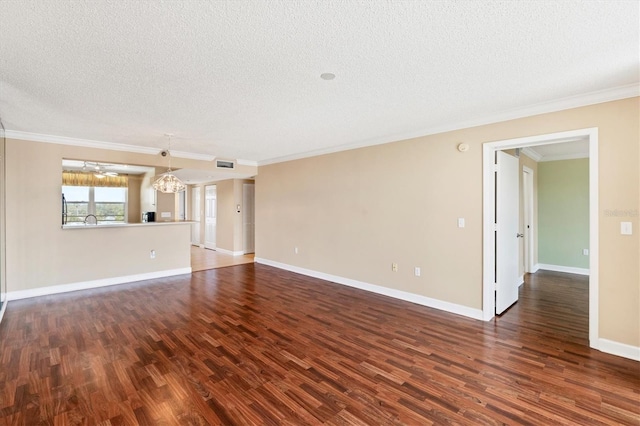 interior space with visible vents, ornamental molding, dark wood finished floors, and a textured ceiling