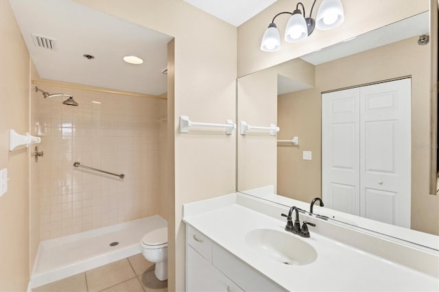 bathroom with visible vents, tiled shower, toilet, tile patterned flooring, and vanity