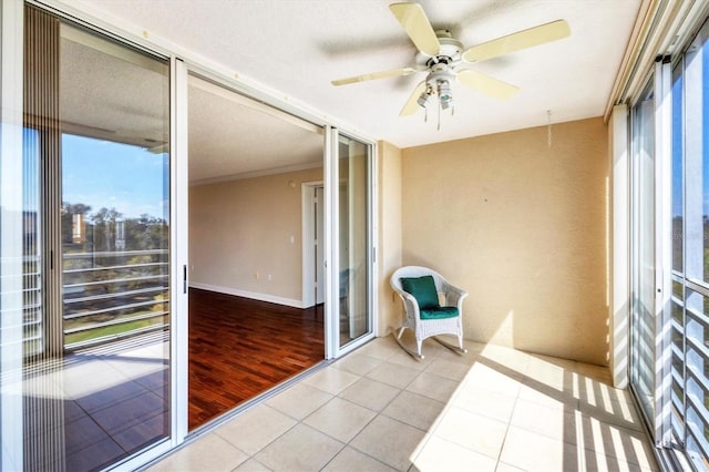 sunroom / solarium featuring ceiling fan