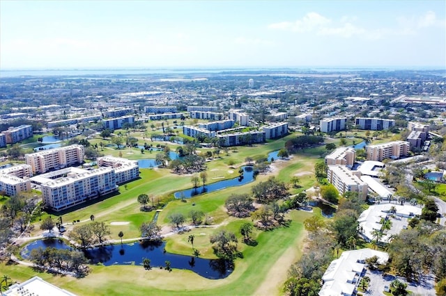 bird's eye view with view of golf course, a water view, and a city view