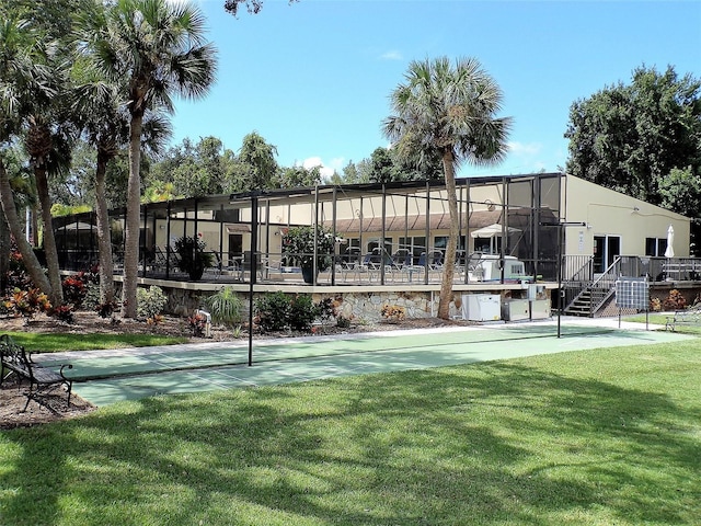 exterior space with shuffleboard and a lawn