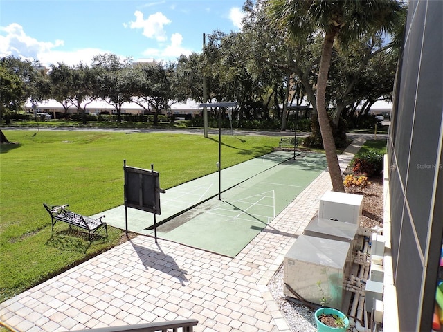 surrounding community featuring shuffleboard and a yard