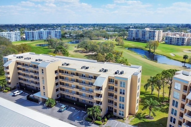 birds eye view of property with a water view and golf course view