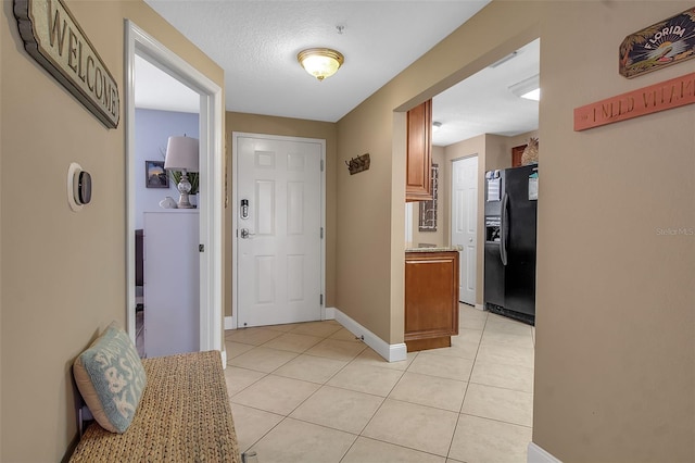 entrance foyer with baseboards and light tile patterned flooring