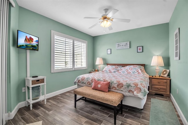 bedroom with baseboards, a ceiling fan, and wood finish floors