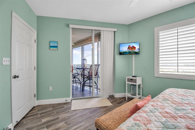 bedroom featuring access to exterior, wood tiled floor, and baseboards