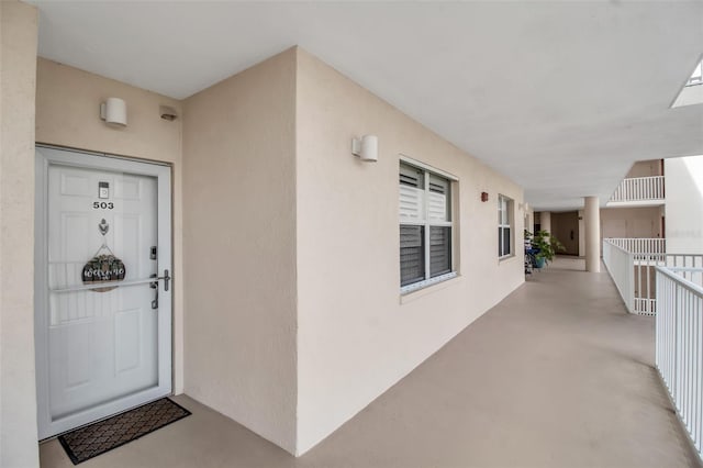 property entrance with stucco siding