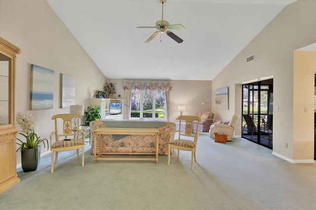 living area featuring a wealth of natural light, carpet flooring, and visible vents