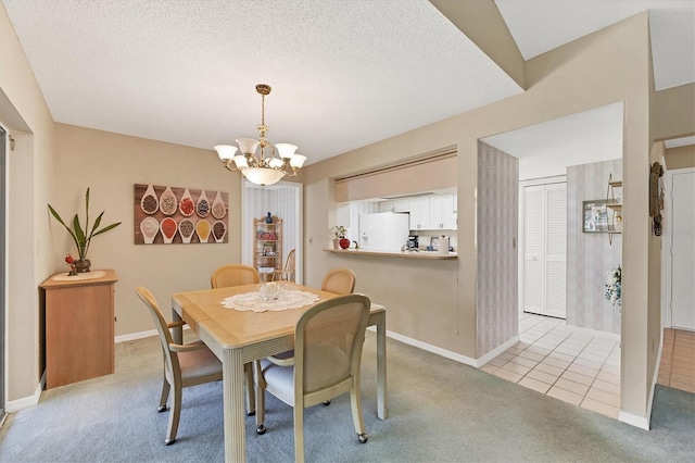 dining area featuring light tile patterned floors, a textured ceiling, a chandelier, light carpet, and baseboards