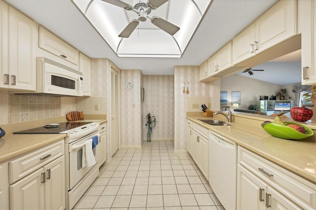 kitchen with ceiling fan, light tile patterned flooring, white appliances, a sink, and light countertops