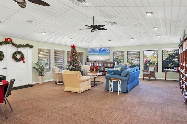 carpeted living room with a ceiling fan, visible vents, and plenty of natural light