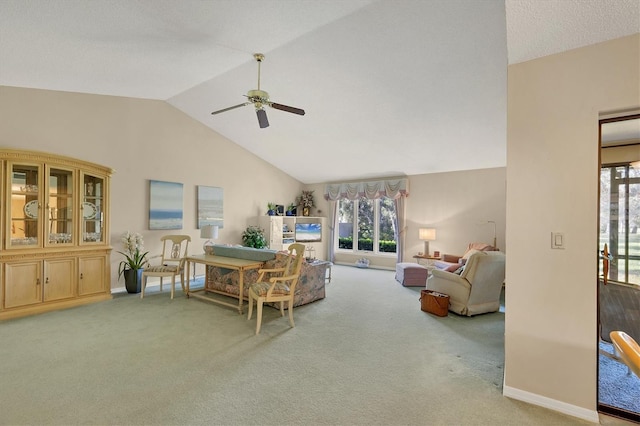 sitting room with vaulted ceiling, ceiling fan, carpet flooring, and baseboards