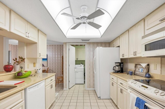 kitchen with white appliances, washer / clothes dryer, light countertops, and a ceiling fan