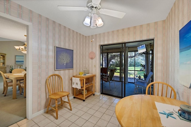 dining space featuring baseboards, a textured ceiling, light tile patterned flooring, and wallpapered walls