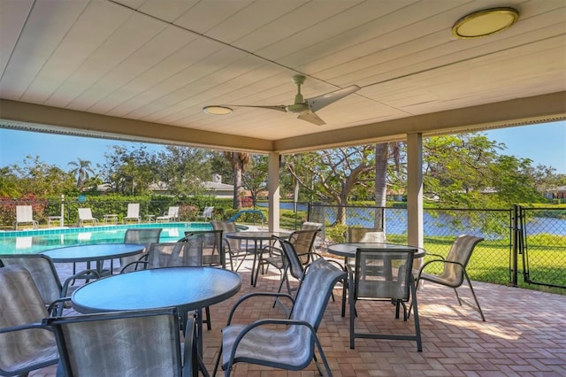 view of patio featuring fence, a fenced in pool, and a ceiling fan