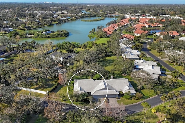 drone / aerial view with a water view and a residential view