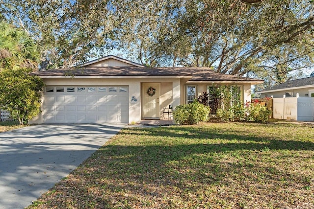 ranch-style home featuring driveway, an attached garage, fence, a front lawn, and stucco siding