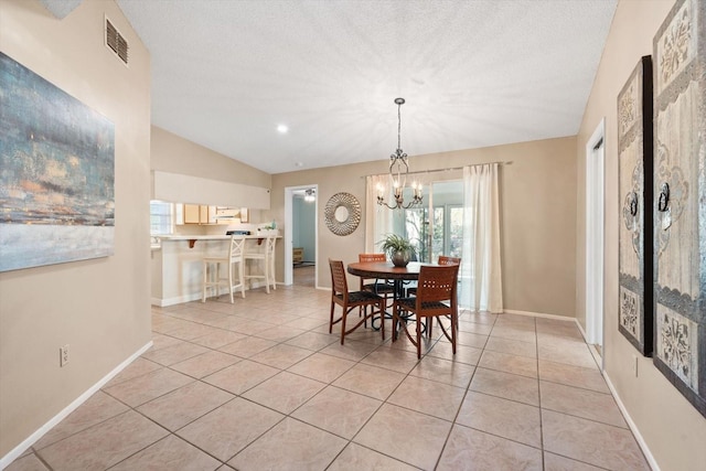 dining room featuring lofted ceiling, light tile patterned floors, baseboards, and visible vents