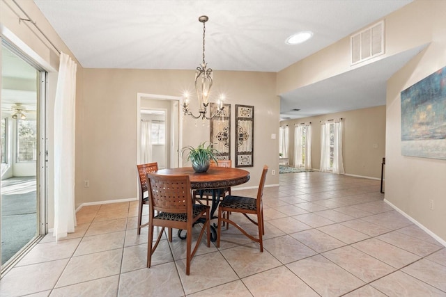 dining room featuring light tile patterned floors, a wealth of natural light, visible vents, and baseboards