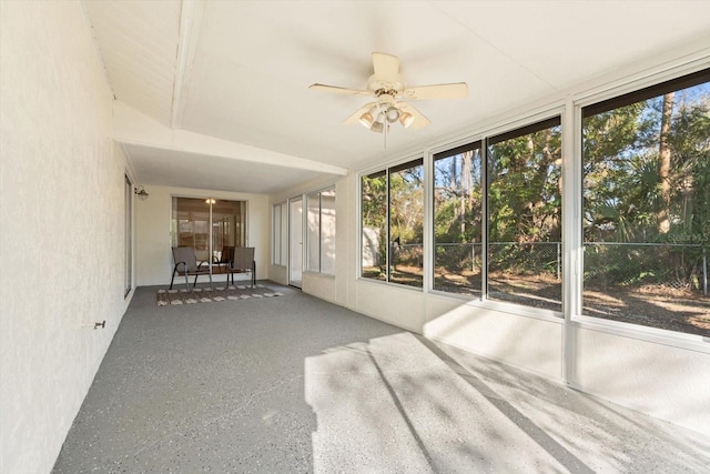 unfurnished sunroom with a wealth of natural light and a ceiling fan