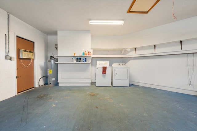 garage featuring independent washer and dryer, electric water heater, and a wall mounted air conditioner