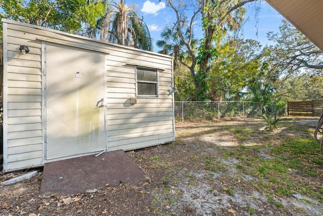 view of shed featuring fence