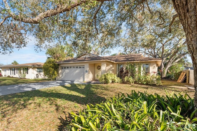 ranch-style home with an attached garage, concrete driveway, a front yard, and stucco siding