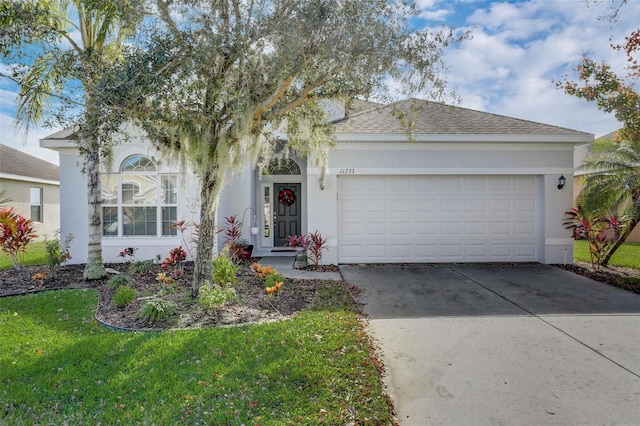 ranch-style home featuring a front yard, driveway, an attached garage, and stucco siding