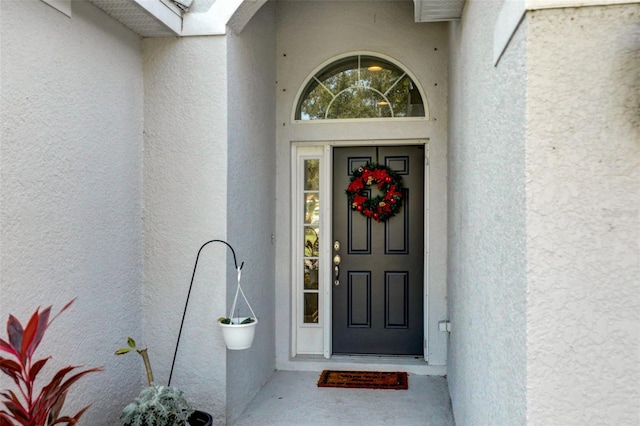 property entrance with stucco siding