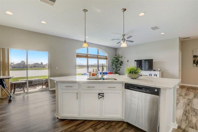 kitchen featuring a sink, white cabinets, a center island with sink, dishwasher, and decorative light fixtures