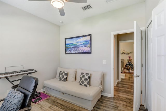 office with ceiling fan, wood finished floors, visible vents, and baseboards