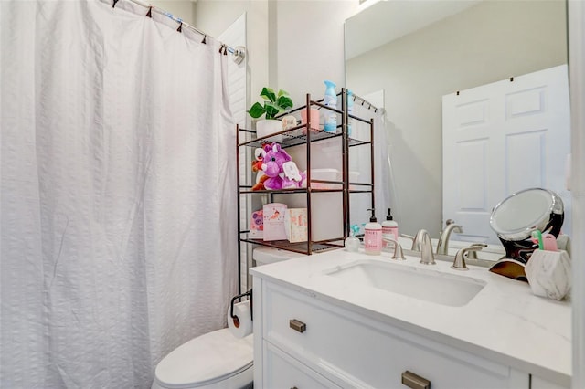 bathroom with toilet and vanity