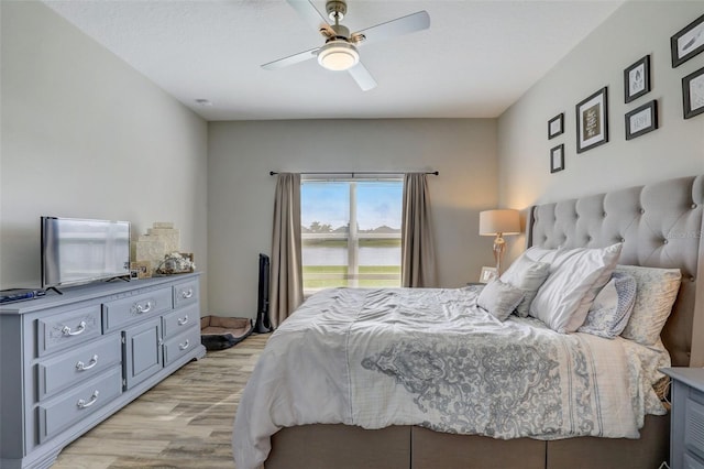 bedroom featuring a ceiling fan and light wood finished floors