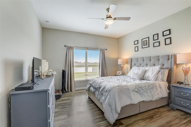 bedroom featuring a ceiling fan and wood finished floors