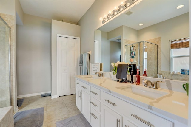 full bath featuring a sink, a shower stall, and tile patterned floors