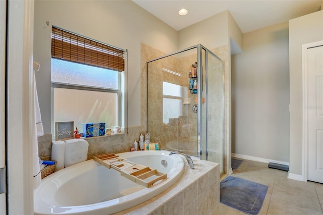 full bathroom with a stall shower, a garden tub, baseboards, and tile patterned floors