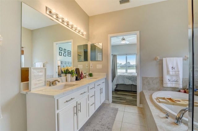 ensuite bathroom featuring double vanity, tile patterned flooring, ensuite bath, and a sink