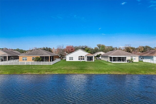 property view of water featuring fence and a residential view