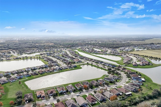 birds eye view of property with a water view and a residential view