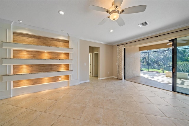 unfurnished living room with light tile patterned floors, visible vents, baseboards, ceiling fan, and crown molding