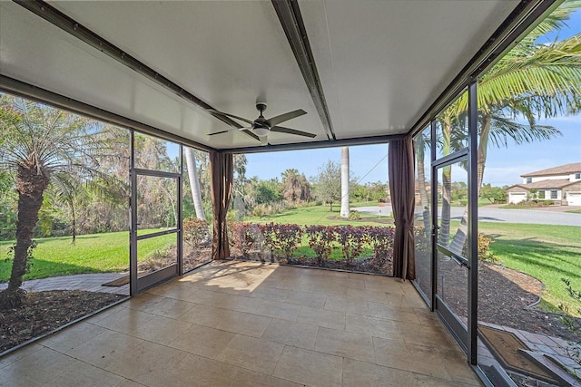 unfurnished sunroom featuring ceiling fan