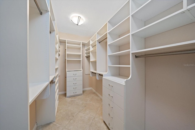 spacious closet with light tile patterned floors