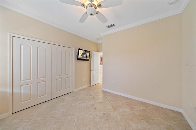 unfurnished bedroom with baseboards, a closet, visible vents, and crown molding