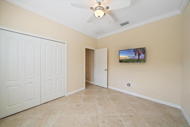 unfurnished bedroom with light tile patterned floors, visible vents, baseboards, crown molding, and a closet