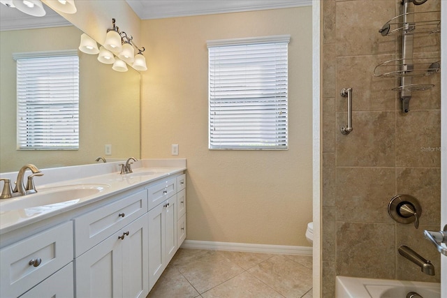 bathroom featuring baseboards, ornamental molding, a sink, and tile patterned floors