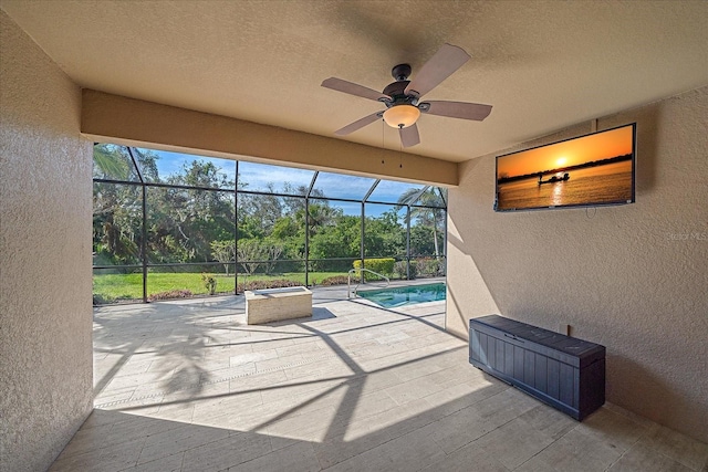 view of patio featuring a lanai, ceiling fan, and an outdoor pool