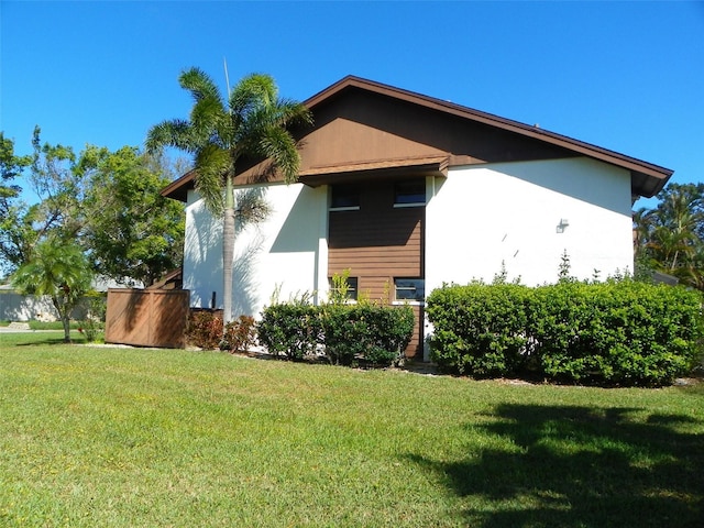 view of property exterior featuring a lawn and stucco siding